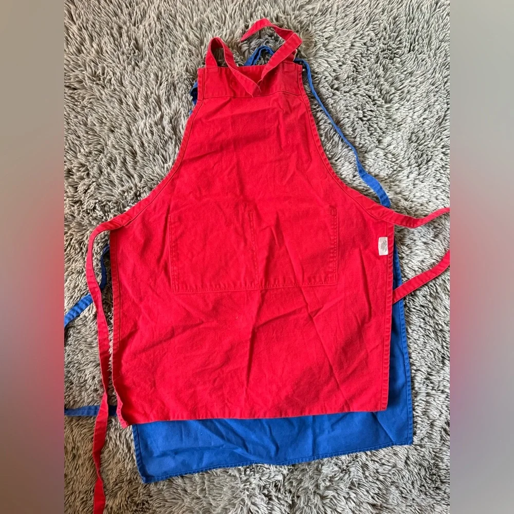 Set of Two Williams-Sonoma cotton bib aprons in red and blue.